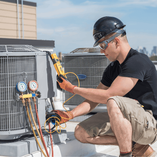 HVAC technician servicing air conditioning unit